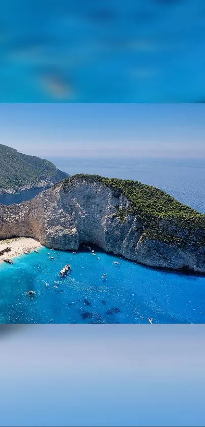 Cliffside beach with azure waters and sandy shores under a clear blue sky.