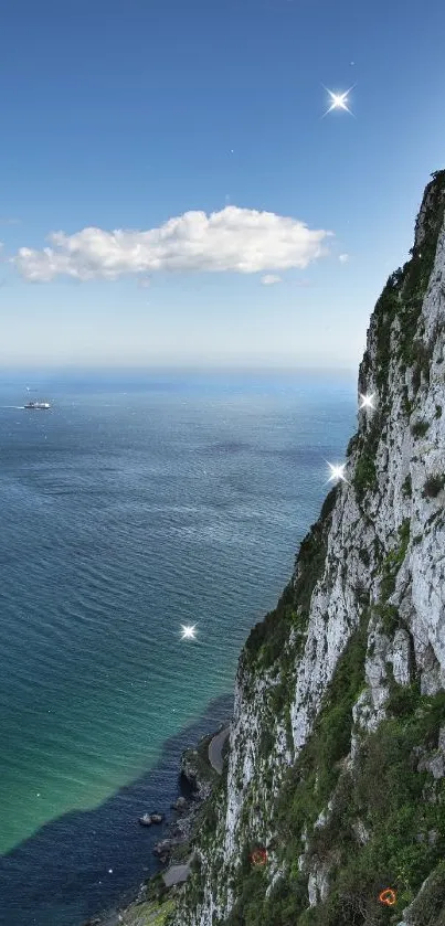 A stunning view of a coastal cliffside with a bright blue sea and clear skies.