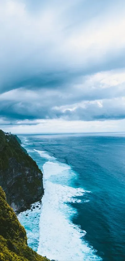 Lush green cliffs meet the ocean under blue cloudy skies in stunning wallpaper.