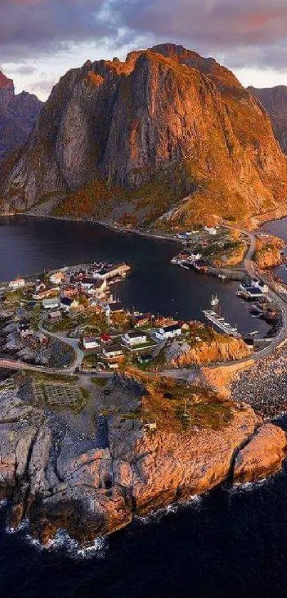 A stunning view of a coastal mountain with a small village by the sea at sunset.