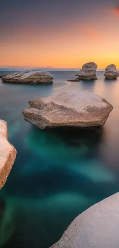 Coastal sunset view with rocks and calm ocean.