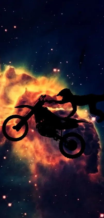 Motocross rider silhouetted against a vibrant cosmic nebula with stars.