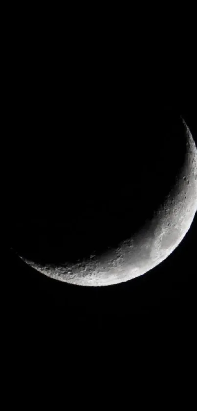 A crescent moon against a dark night sky wallpaper.