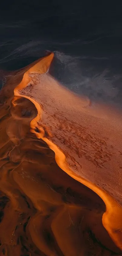 Vibrant orange desert dune mobile wallpaper with dark hues.