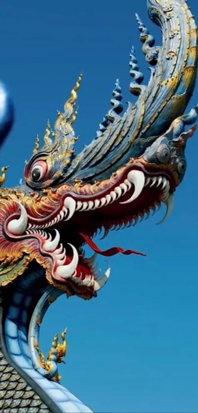 Intricate dragon sculpture with blue sky background.