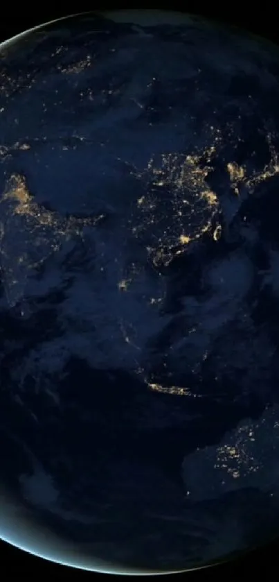 Earth at night with city lights visible from space, dark blue cosmic background.