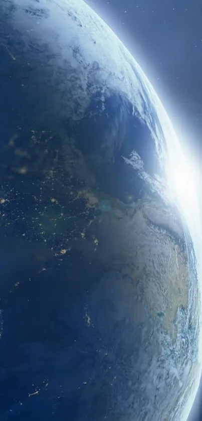 Stunning view of Earth from space with sunlight over the horizon.