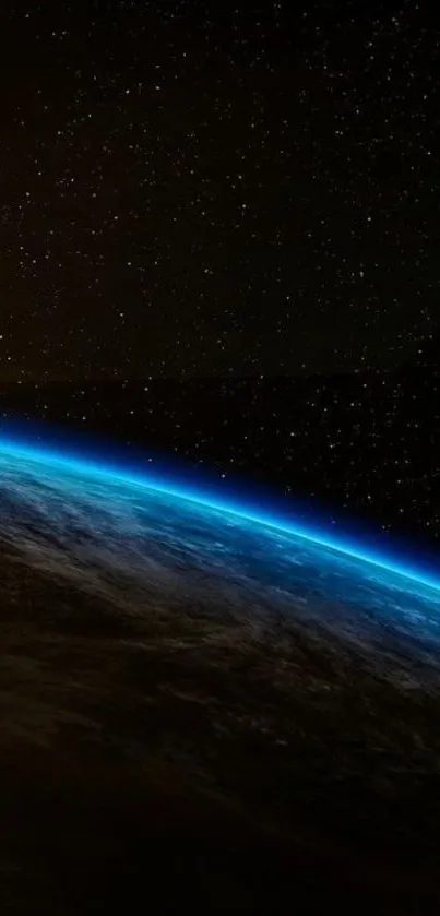 Breathtaking view of Earth from space with a glowing atmosphere and starry sky.