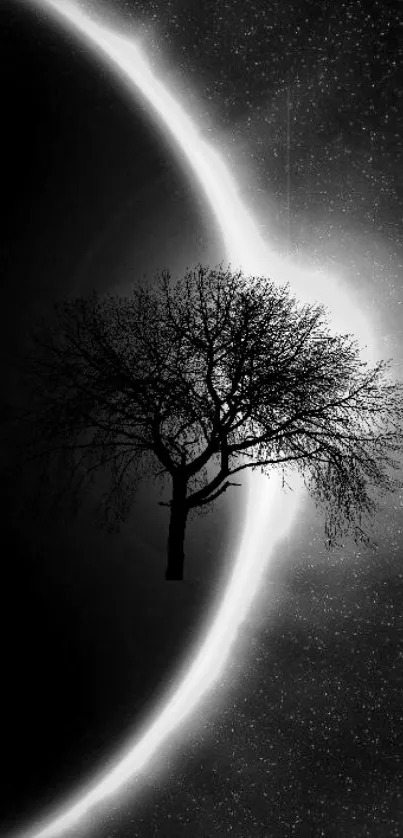 Black and white wallpaper with a tree silhouette against a solar eclipse backdrop.