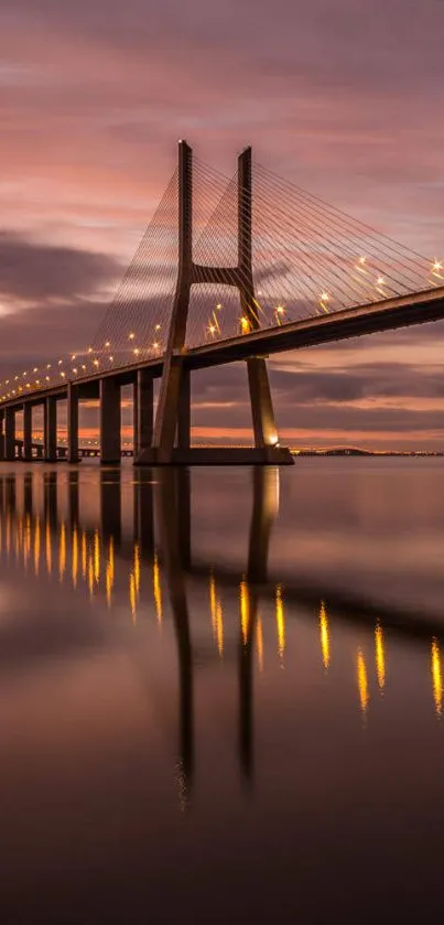 A stunning dusk view of a lit bridge with water reflection and colorful sky.