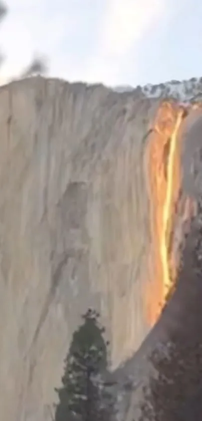 Fiery waterfall at sunset on Yosemite cliff.