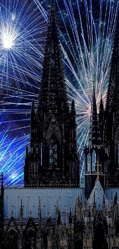 Fireworks burst over a cathedral at night, illuminating the sky.