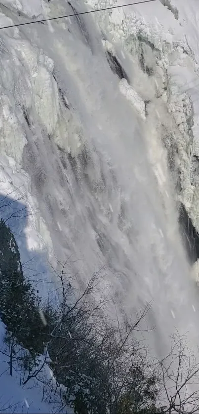 Frozen waterfall with cascading ice and snow creating a stunning winter scene.