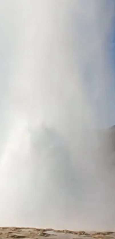 Geyser eruption under clear blue sky.