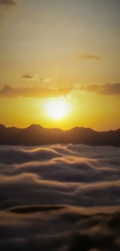 Golden sunrise over mountains and clouds.