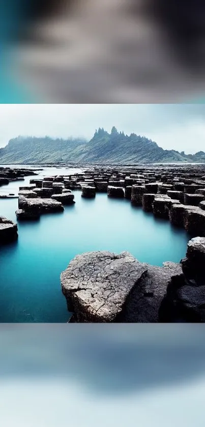 Serene hexagonal rock formation with mountain backdrop.