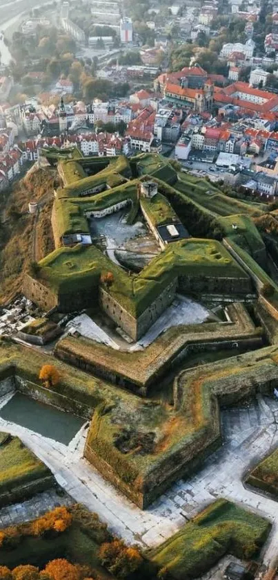 Aerial view of star-shaped fortress with autumn landscape.