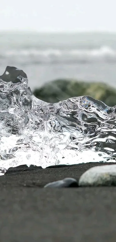 Crystal-clear ice on a black sand beach with ocean waves.