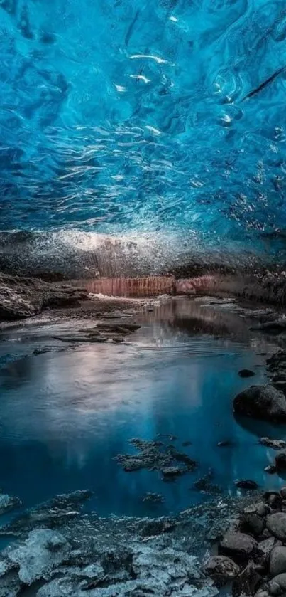 Vivid blue ice cave with a serene pool reflection.