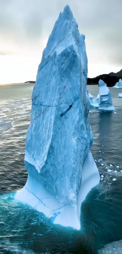 Majestic iceberg tower in serene ocean background.