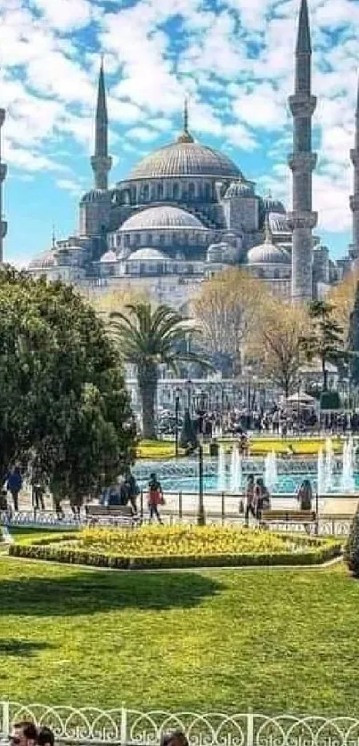 Istanbul's Blue Mosque amidst gardens and tourists on a sunny day.