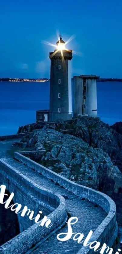 Lighthouse on coastal path under a night sky.