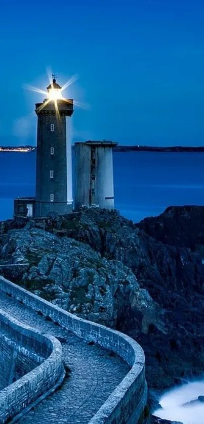 Lighthouse on rocky cliff against deep blue ocean at dusk.