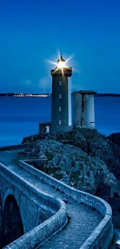 Lighthouse shining in serene night ocean scene