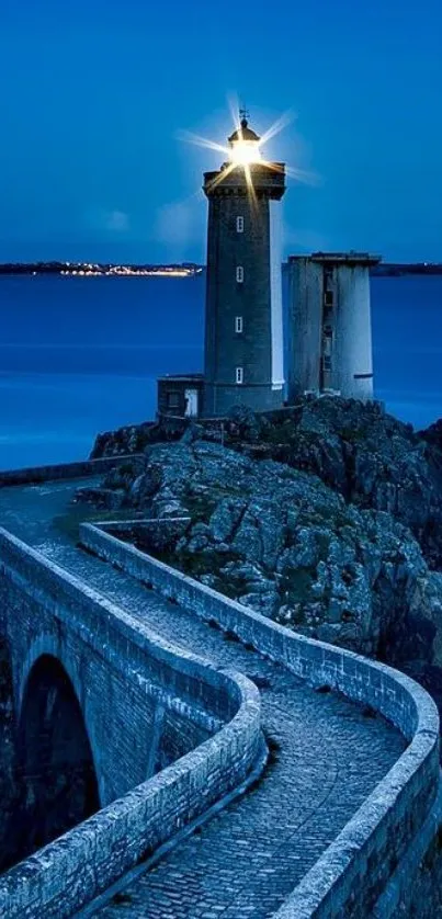 Lighthouse against a twilight blue ocean backdrop.