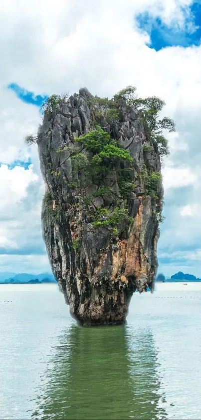 Majestic limestone rock in clear water under a vibrant blue sky.