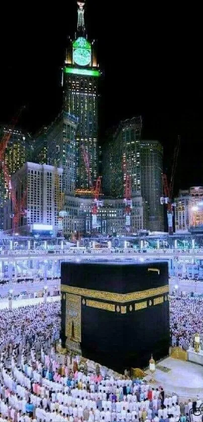 Kaaba at night surrounded by city lights and worshippers.