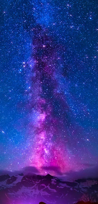 Milky Way with pink and purple starry sky over mountains.