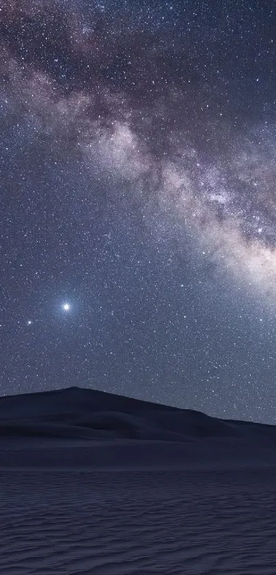 Starry night sky over a serene desert landscape.