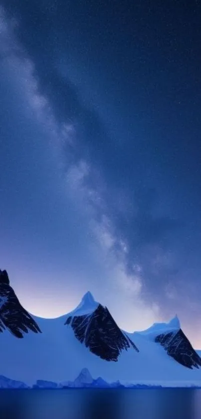 Majestic snowy mountains under a starry Milky Way sky at night.