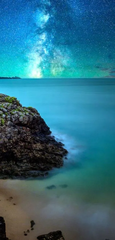 Spectacular Milky Way over tranquil ocean and rocky shore at night.