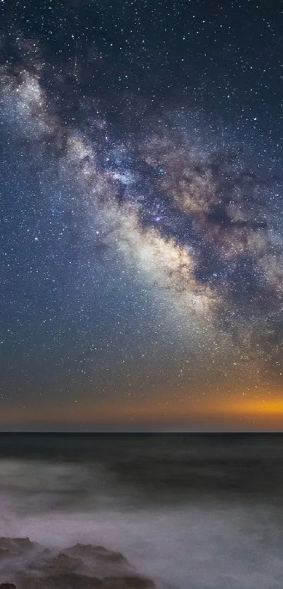 Milky Way galaxy over tranquil ocean at night, starry sky phone wallpaper.