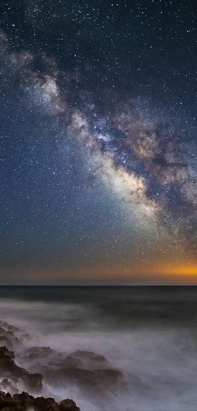 Milky Way visible over ocean waves at night.