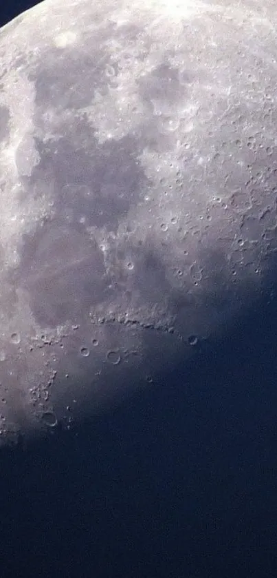 High-resolution wallpaper of the moon's surface with craters against a dark blue sky.