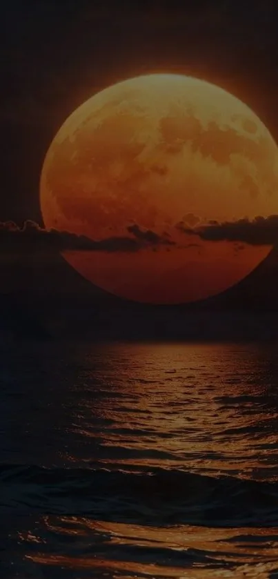 Dark orange moon reflecting over a calm ocean at night.