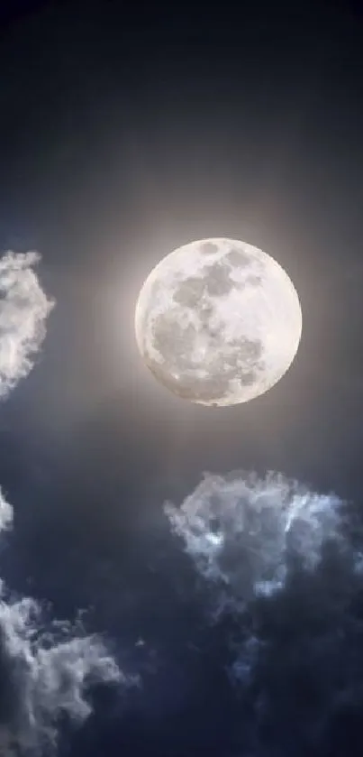 A full moon shines brightly among dark, dramatic clouds in a night sky wallpaper.