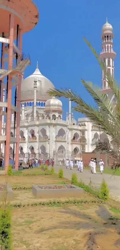 Vibrant mosque view with palm trees under a clear blue sky.