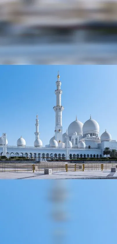 Majestic mosque under a clear blue sky, showcasing stunning Islamic architecture.