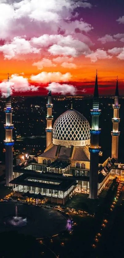 A mosque illuminated against a vibrant sunset sky, creating a stunning mobile wallpaper.