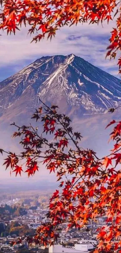 Mount Fuji with red autumn leaves and cityscape.