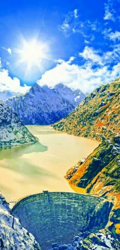 A scenic view of a mountain dam under a vibrant blue sky with snow-capped peaks.