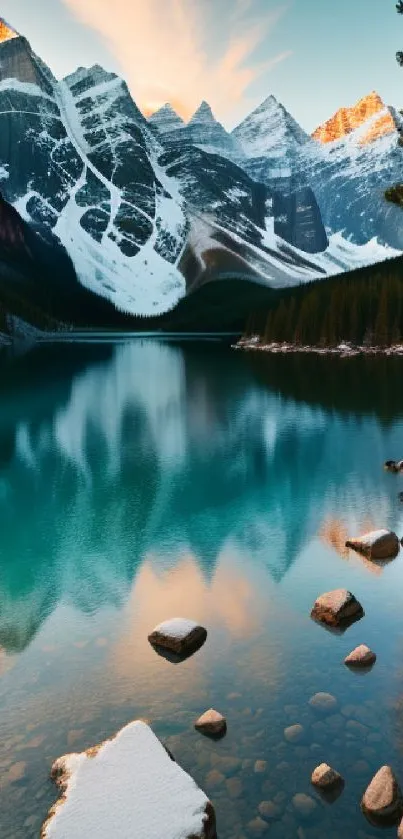 Scenic mountain lake with teal water reflection and snow-capped peaks at sunset.