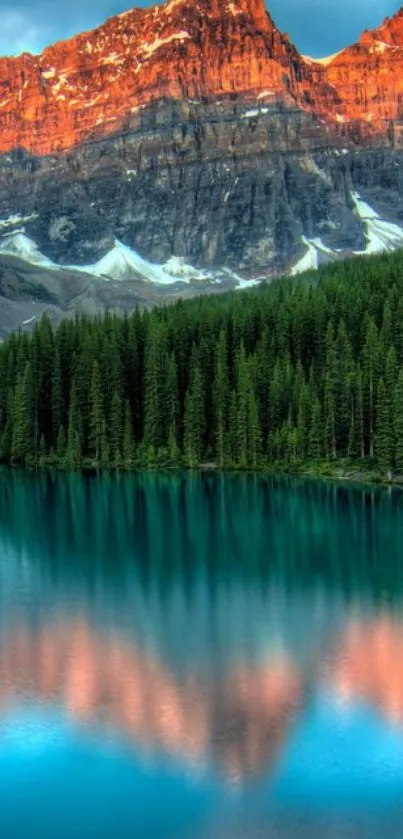 Mountain lake with forest and sunset glow on peaks.