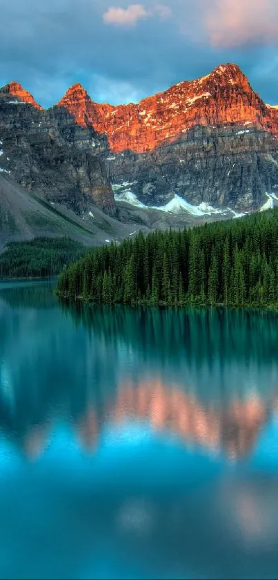 Mountain lake reflecting sunset-lit peaks and forest.