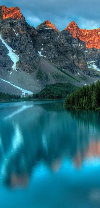 Breathtaking mountain lake at sunrise with reflections of peaks and forest.