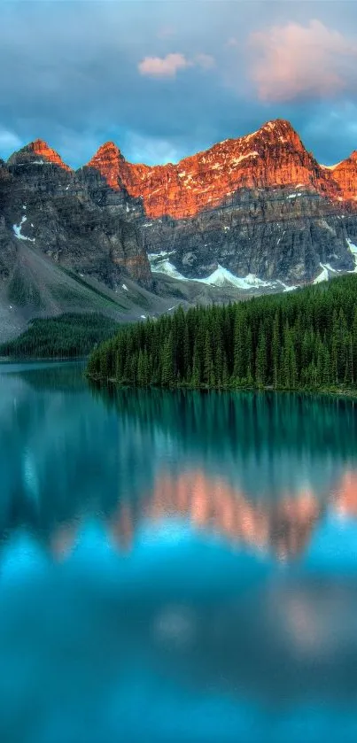 A serene mountain lake reflecting snowy peaks at sunset.